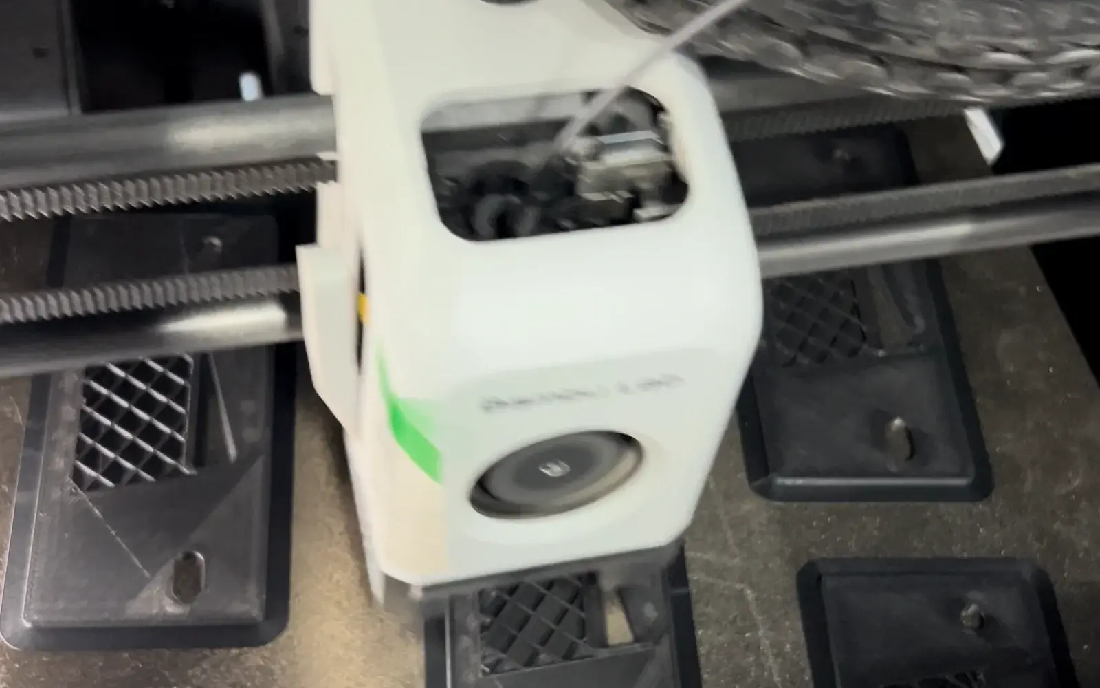 Black rectangular frame-shaped parts on a printer build plate