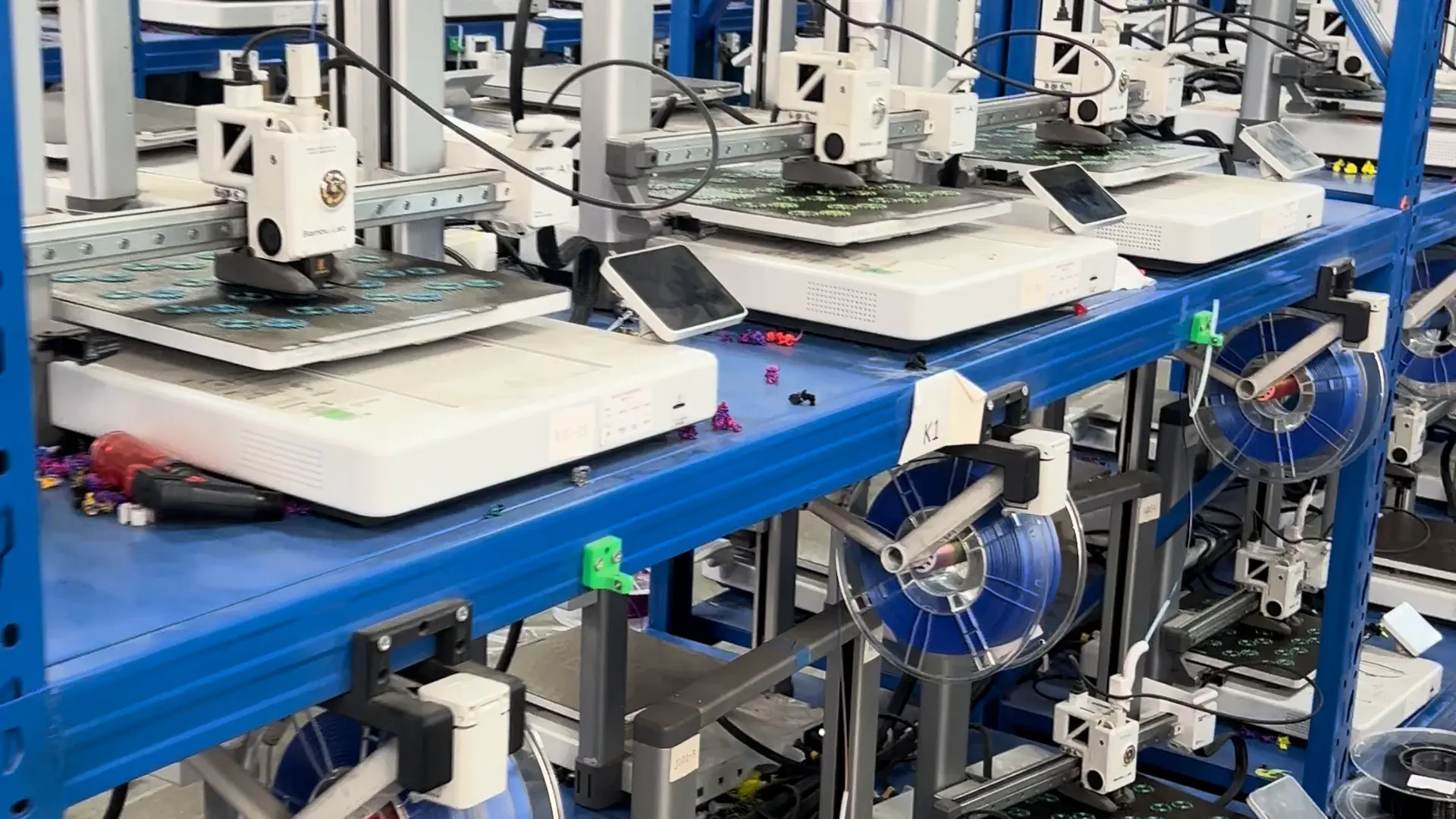 FDM printers and filament spools on production racks