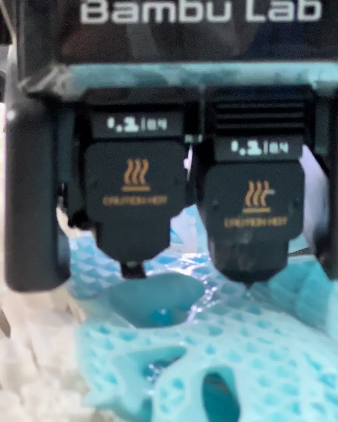 Bambu Lab toolheads printing light blue parts at close range