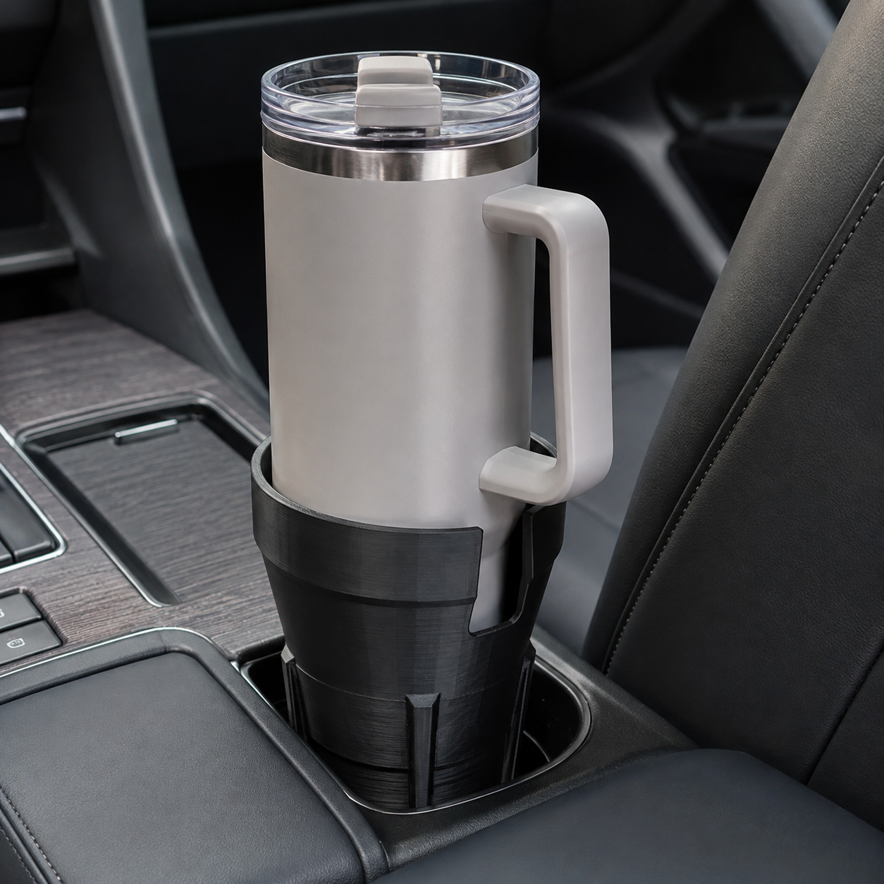 Black 3D printed vehicle cup holder supporting a handled tumbler